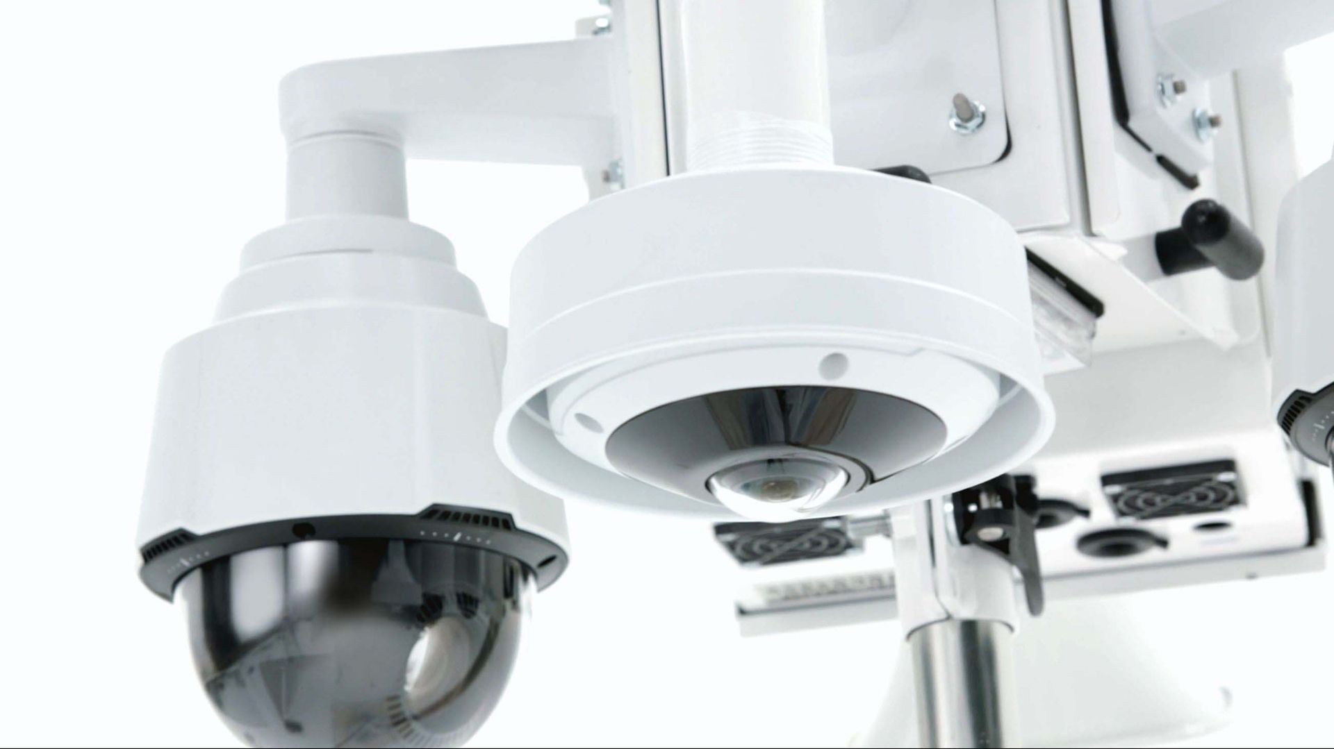 Close-up of a white surveillance camera system with multiple lenses and sensors.